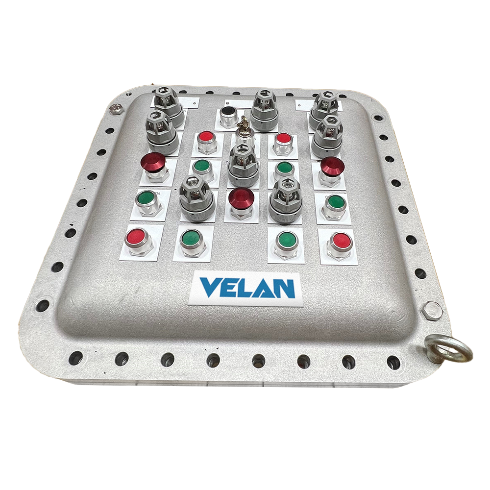 Square metallic control panel with multiple toggle switches. Each switch has a corresponding red or green indicator button. The panel is labeled "VELAN" and has a ring handle on one corner.